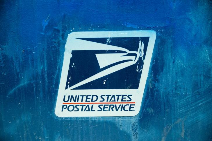 postal service signage on painted wall
